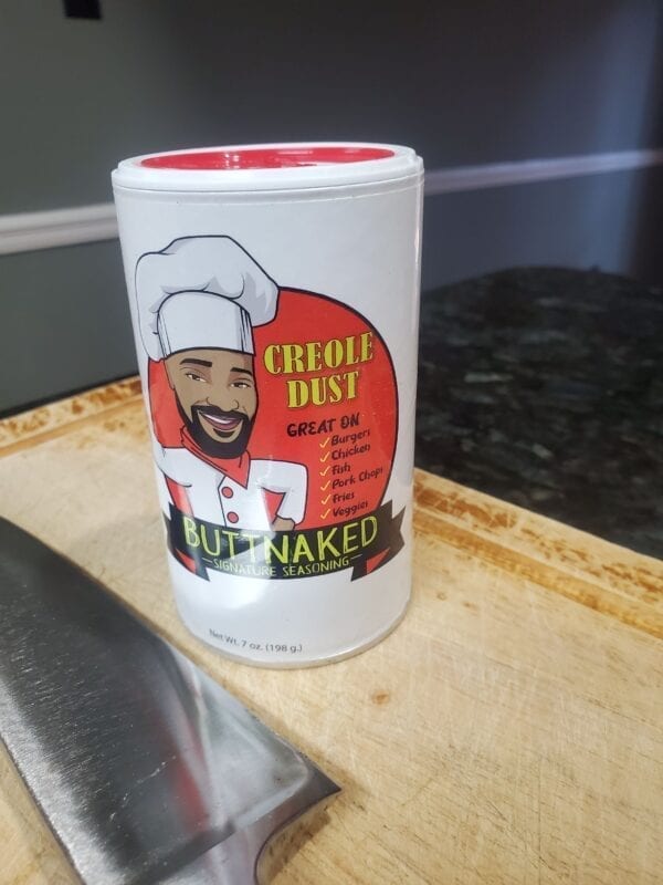 A can of naked chef 's best seasoning sitting on top of a counter.